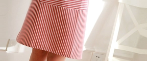 Detailed view of red and white striped cotton linen apron with natural texture