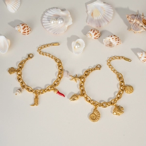 Golden stainless steel ocean-themed charm bracelet with starfish and shell charms