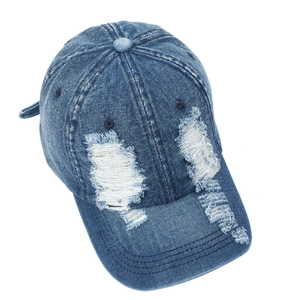 Close-up of distressed denim baseball cap with vintage wash and ripped details