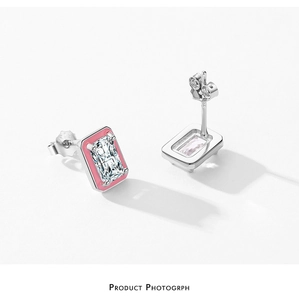 Detail of S925 silver stud earrings with emerald-cut zircon and pink enamel border