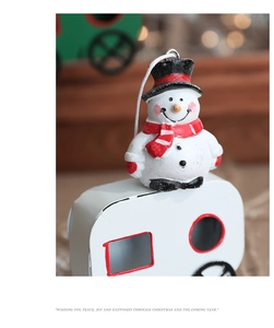 Close-up of a festive snowman hanging ornament with vibrant hand-painted details