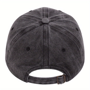 Detail view of adjustable bronze buckle and washed cotton texture on vintage baseball cap