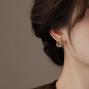 Vintage gold hollow triangle earrings with colorful rhinestones on female model
