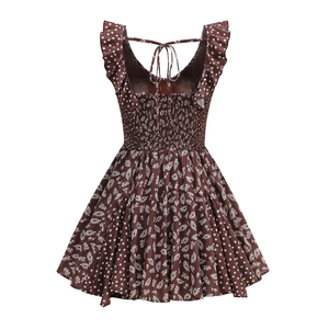 Close-up of ruffled straps and elastic smocked bodice on brown floral polka dot dress