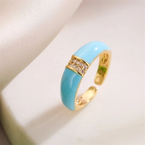 Detail of 18K gold ring featuring sky blue enamel and sparkling pavé set crystals
