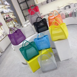 Multi-color hollowed-out jelly beach bags in diverse shades displayed on display stands