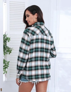 Detail view of the brushed fabric texture and classic green plaid pattern on the shirt