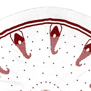 Close-up of intricate red embroidery on a white knitted Christmas tree skirt fabric
