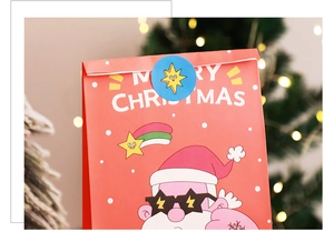Detail of red Christmas gift bag with cartoon Santa in sunglasses and Merry Christmas text