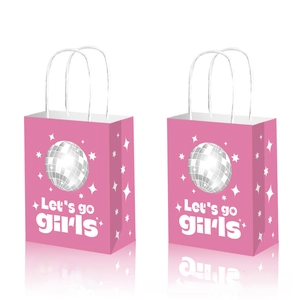 Close-up of pink disco cowgirl paper gift bags with Let's go girls text and star patterns