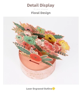 Detail view of 3D pop-up flower card featuring laser-cut bouquets and gold Wishes text