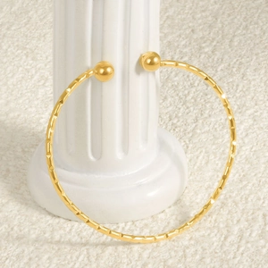 Adjustable 18k gold plated stainless steel cuff bracelet with geometric faceted texture
