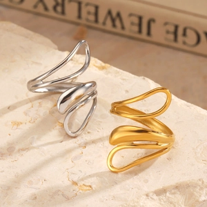 Minimalist stainless steel open rings in gold and silver finish on decorative stone base