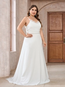 Detail of white satin evening gown featuring delicate lace V-neckline and elegant straps