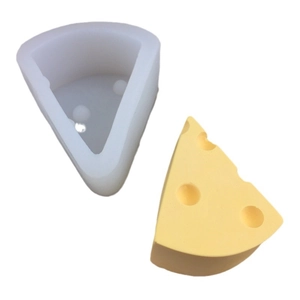 Realistic cheese slice silicone mold with yellow finished cheesecake candle on white background