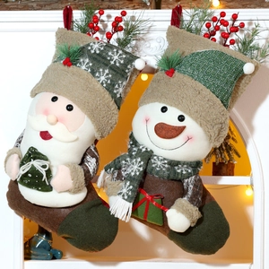 Close-up of knit Christmas stockings featuring Santa and Snowman with plush details