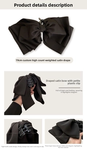 Detail of large black satin bow hair claw clip with triple-layer design and non-slip teeth