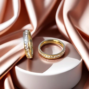 Close-up of gold titanium steel eternity rings with square-cut sparkling zirconia stones