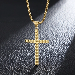 Golden stainless steel cross pendant necklace with wheat pattern on black leather surface