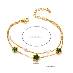 Detailed view of a double-layer gold chain bracelet with green stars and faux pearls