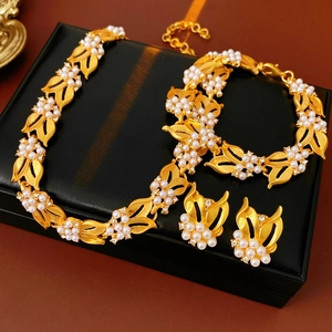 Detail shot of vintage style gold leaf jewelry set with white pearls and zircons