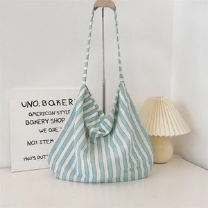 Close-up of blue and white striped canvas tote bag showing soft knit fabric and large capacity