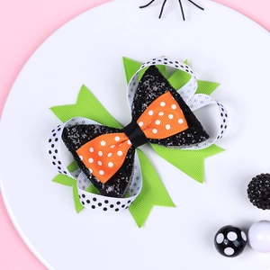 Detail of layered Halloween bow clip featuring black sequins and colorful polka dot ribbons