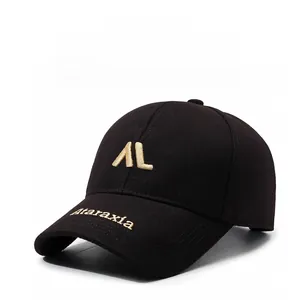 Detailed close-up of golden 3D embroidery on a black structured cotton baseball cap