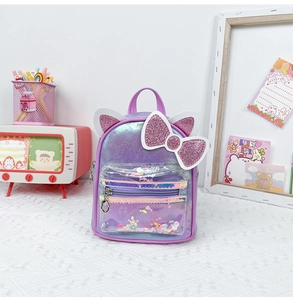 Detail of sequin cat ear backpack with a large glitter bow and transparent front pocket