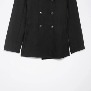 Classic black wool blend double-breasted coat featuring embossed metal buttons
