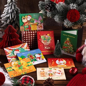 Macro detail of 3D Christmas pop-up cards with Santa, snowman and reindeer designs