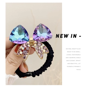 Detail of high-elastic black hair tie featuring a sparkling crystal bow decoration