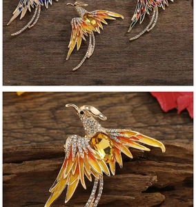 Close-up of a colorful phoenix brooch with rhinestone inlay and enamel finish