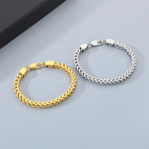 Macro detail of 6mm gold and silver franco chain bracelet with secure fold-over clasp