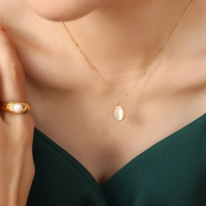 Vintage gold cat eye stone pendant necklace and pearl ring set on model