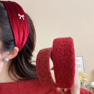 Close-up of velvet red headband with silver bow detail and plush textured winter hairbands