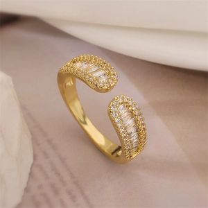 Macro shot of a gold open ring with rectangle and round cubic zirconia inlays