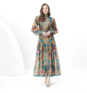 Close-up of vintage baroque gold patterns on a deep teal long-sleeve printed dress