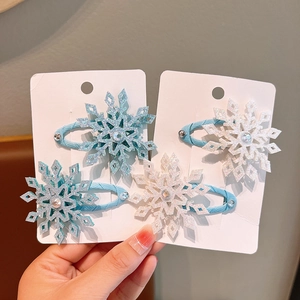 Sparkly snowflake hair clips for girls with blue and white glitter and center rhinestones