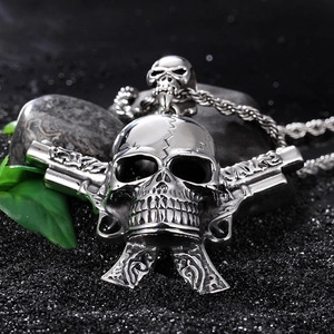 Punk silver skull warrior pendant with dual pistols on a black textured background