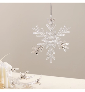 Close-up of clear acrylic snowflake ornament with silver glitter details and hanging string