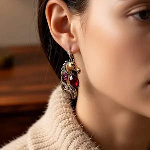 Vintage gold horse head earrings with red gemstone and crystals on model for luxury look