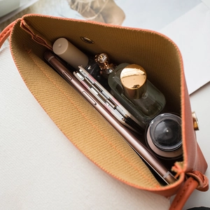 Chic brick orange small square crossbody bag showing spacious interior and magnetic closure