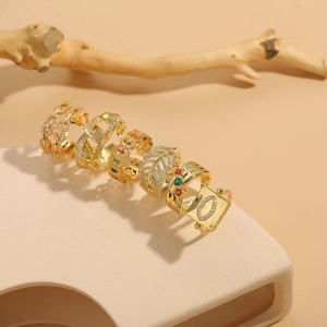 Detail of 14K gold-plated rings set with colorful zircons and geometric hollow patterns