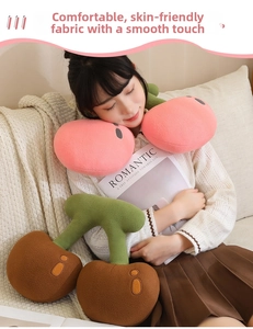 Detail showing plush cherry-shaped pillow with soft short velvet fabric and full stuffing