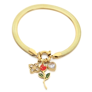 Golden snake chain bracelet with red rose clover and heart pendants on white background