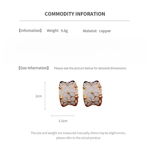 Detailed view of white flower enamel earrings with 18k gold plating and size measurements