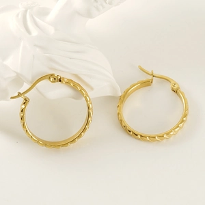 Textured 18K gold plated titanium steel hoop earrings displayed on a white bust statue