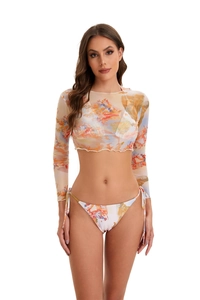 Close-up of abstract print mesh cover-up and matching tie-side bikini with lettuce edges