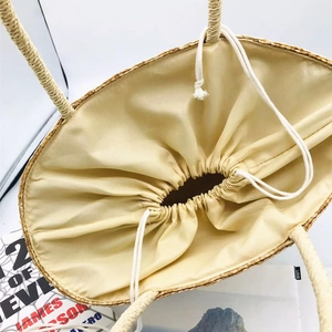 Large lemon embroidered straw beach tote with rope handles and drawstring closure